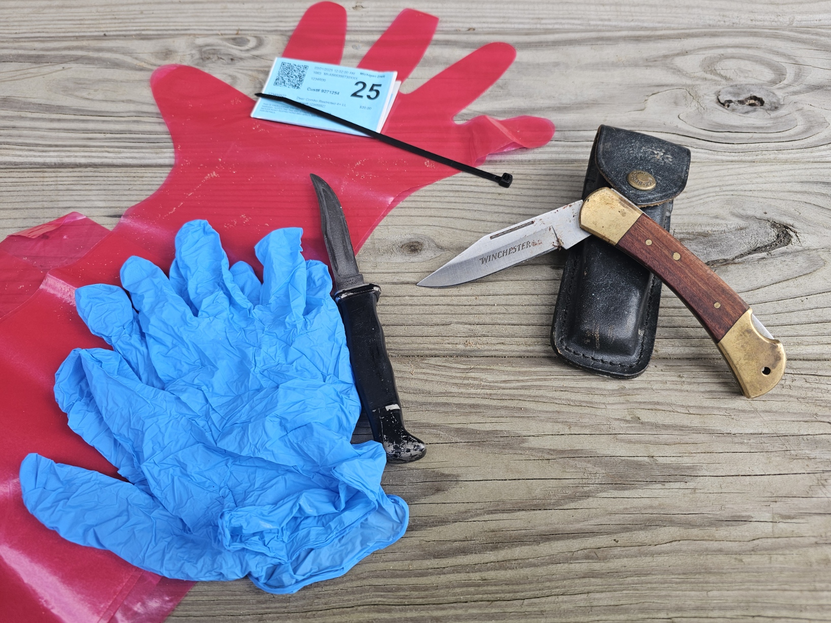 The perfect field dressing kit - long sleeve gloves, two knives, and a deer tag