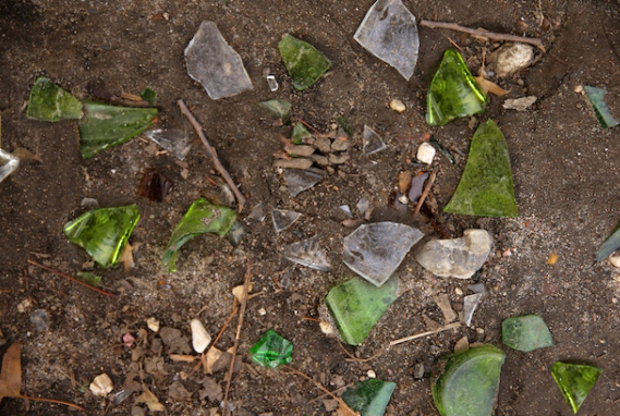a pile of broken glass that was found on a ditch bottom