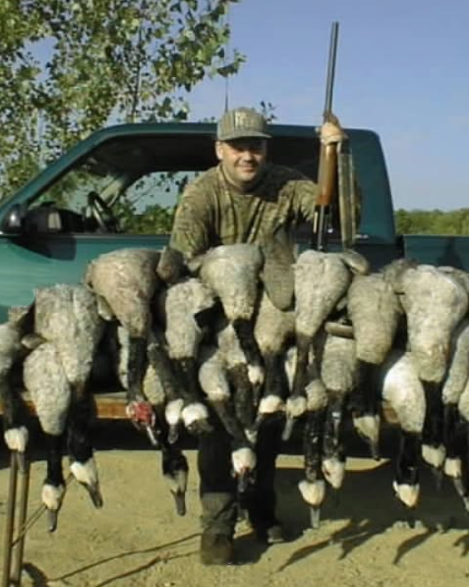 A man and his hunting party's canada goose harvest.
