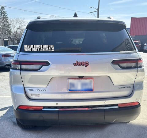 A car with a bumper sticker that indicates an anti-hunting or anti-trapping sentiment
